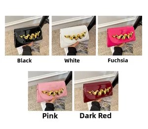 Detailed collection of shiny patent leather evening bags with wavy gold metal closures