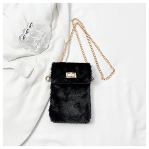 Detail of black faux fur mini bag with golden chain strap and rectangular turn-lock
