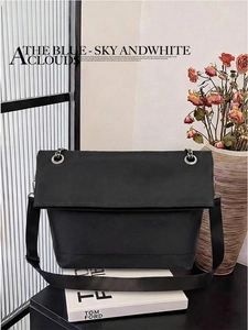 Detail of black matte leather messenger bag with adjustable silver eyelet nylon strap
