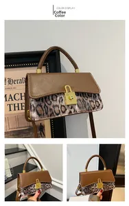 Detail of retro shoulder bag with leopard print stitching and golden twist lock closure