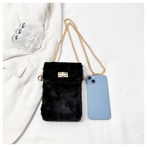 Detail of black faux fur mini bag with gold chain strap and smartphone size comparison