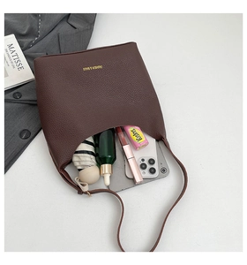 Interior view of soft brown leather tote bag showing spacious storage for daily items