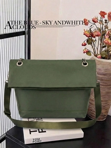 Detail of olive green messenger bag with silver metal chain and fabric shoulder strap
