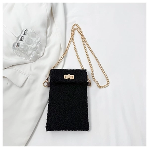 Detail of black faux shearling mini crossbody bag with gold metallic twist lock