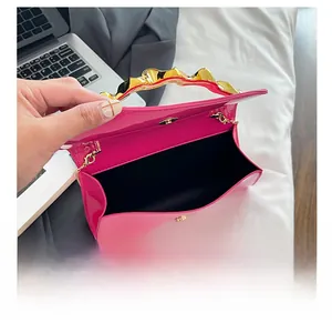 Top view detail of the pink patent leather crossbody bag with spacious inner compartment
