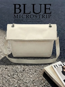 Close-up of wide fabric shoulder strap and metal hardware on beige minimalist tote bag