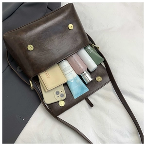 Detail view of large capacity dark brown retro leather tote bag showing internal storage
