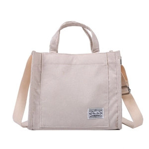 Beige corduroy tote bag with adjustable shoulder strap and minimalist vintage design