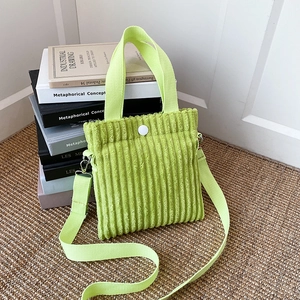 Vertical fluorescent green corduroy mini tote bag with adjustable crossbody strap