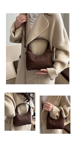 Detail of leopard print hobo bag with brown leather handles and textured suede material