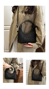 Detail view of black leopard print hobo bag in soft suede with silver hardware