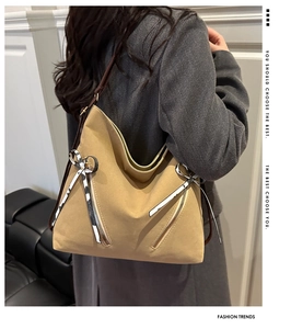 Vue portée d'un grand sac hobo kaki avec fermetures éclair décoratives et nœud chic
