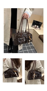 Detail of coffee brown patent leather Boston bag with bow pockets and beaded tassel
