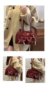 Detail of dark red tote bag with bow pockets and colorful beaded charms