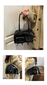 Detail view of black patent leather bag with bow pockets and bead pendant charm