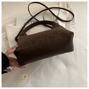 Top-down view of retro leopard print handbag with leather texture and silver metal buckle