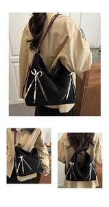 Detailed views of a black canvas tote with leather straps and floral bow decoration