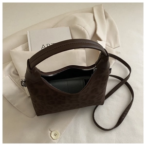 Interior view of leopard print crossbody bag showing spacious capacity and inner wallet