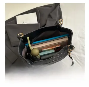 Top view showing large capacity interior of black tote bag with star and moon patterns