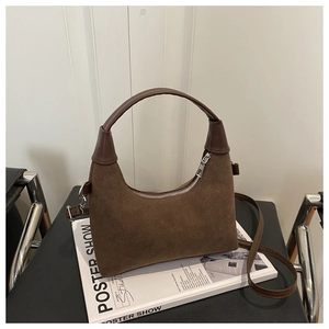 Detail of vintage dark brown suede saddle bag with smooth PU leather trim and silver zipper