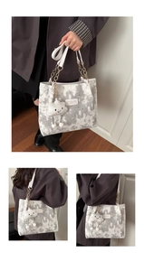 Detailed view of women's tote bag with cloud moon pattern and plush cloud pendant