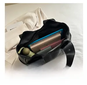 Top view of large black leather tote bag interior showing spacious storage capacity