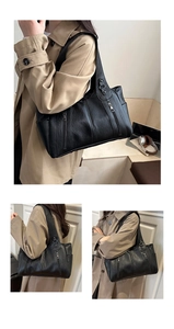Detail of black pebbled leather tote bag with functional zippers and large capacity