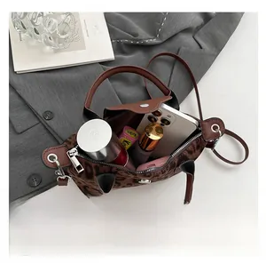 Interior view showing the large capacity of the leopard print handbag with daily items