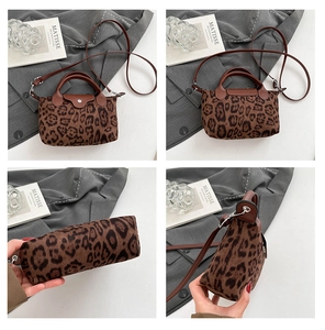 Detail showing leopard print canvas bag with leather trim and adjustable shoulder strap