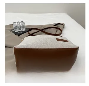 Detailed close-up of durable leather base and woven fabric texture on the shoulder bag