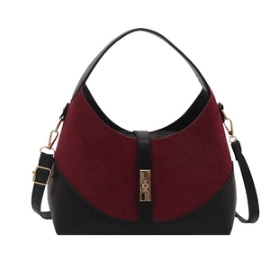 Chic burgundy suede and black leather dumpling bag with gold buckle and adjustable strap