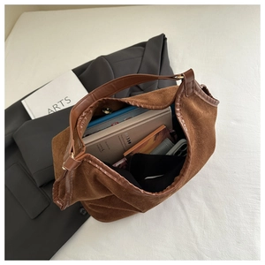 Spacious caramel brown suede tote bag interior showing capacity for books and notebooks