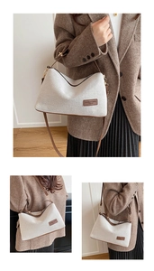 Detail of canvas half-moon bag with brown leather trim and adjustable shoulder strap