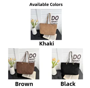 Three colors of quilted chain handbags in khaki, brown, and black on a desk
