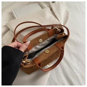 Top view of brown suede bucket bag showing magnetic clasp and spacious fabric interior