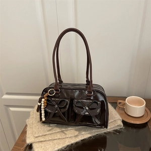 Dark brown patent leather Boston bag with bow accents and vintage beaded charm