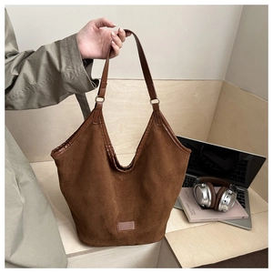 Detail view of large brown vintage tote bag in soft matte leather for daily commute