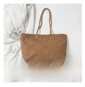 Size comparison of the brown quilted suede chain bag with an autumn elegant style