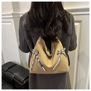 Khaki canvas backpack for women showing back view of carry straps and ribbon detail
