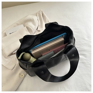 Top view of spacious interior compartments in a large black PU leather tote bag