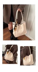 Detail of cream large tote bag featuring smooth leather texture and decorative silk scarf