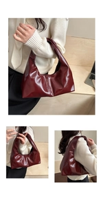 Detail of burgundy glossy leather tote bag showing large capacity and soft pleated design