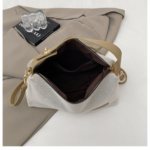 Top view of large canvas and leather tote showing inner lining and metal closure detail