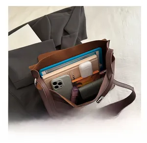 Interior view of large reddish-brown tote bag showing spacious storage for gadgets