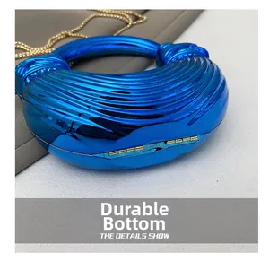 Close-up of metallic blue acrylic evening bag with durable base and gold chain strap