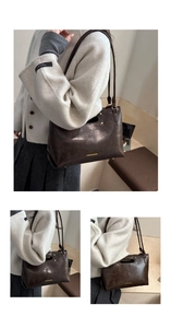 Detail shot of vintage dark brown leather handbag with gold studs and precise stitching