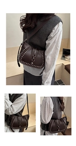 Detail of dark brown rivet hobo bag showing matte leather texture and silver studs