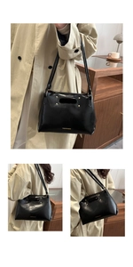 Detail view of black PU leather shoulder bag with golden studs and fashion lettering