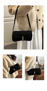 Detail of leopard print underarm bag with gold metal lock and leather shoulder strap