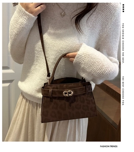 Close-up of brown leopard print bag with soft texture and golden metal buckle detail
